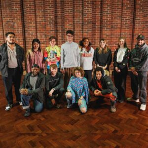 A group of 12 young people stood on stage at Turner Sims