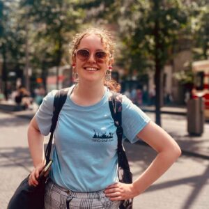 Young woman wearing sunglasses and a light blue t-shirt