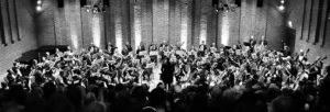 Black and white photograph of a full orchestra at Turner Sims